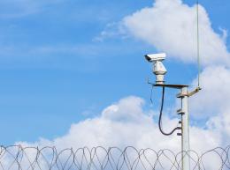 surveillance camera with sky as a background, in a prison