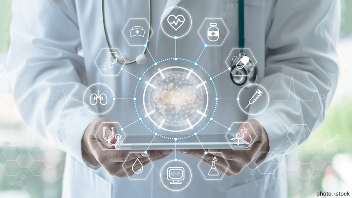  Medical doctor holding tablet showing digital data